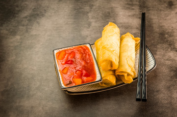 Spring rolls, chopsticks and sauce