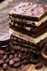 Chocolate bars on table with chocolate tower.