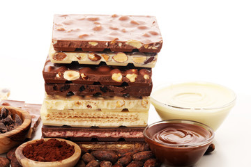 Chocolate bars on table with chocolate tower.