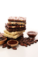 Chocolate bars on table with chocolate tower.