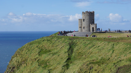 Fototapeta na wymiar O'Brien's Tower built in 1835 as a viewing point for tourists visiting the Cliffs of Moher looming over the Atlantic Ocean in County Clare, Ireland
