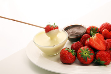 Fondue with Melting chocolate or melted chocolate and strawberry.