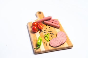 Tasty sausage and bread with lettuce and tomato for lunch