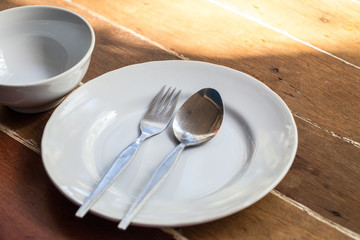 White Melamine tableware. Tableware sets for picnic in holidays on wooden background. dinner sets. lunch at outdoor.