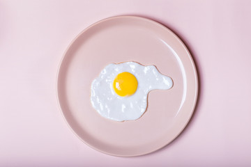 fried eggs on beige plate. Laconic. view from above