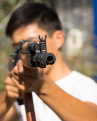 Portrait of a man aiming a gun