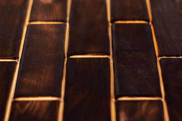 Wooden charred floor of small plates. Bottom view. Floor as an element of the interior.