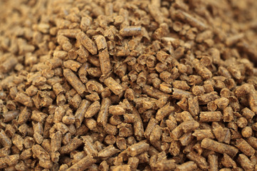Fuel wood pellet close-up. A source of alternative clean energy. A lot of pellet. Natural fuel and energy of future.