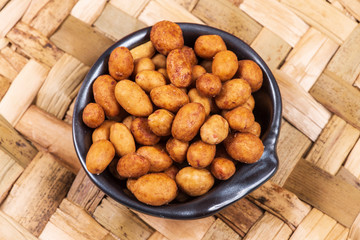 Peanuts coated full in the bowl in a bar
