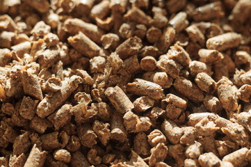 Fuel wood pellet close-up. A source of alternative clean energy. A lot of pellet. Natural fuel and energy of future.