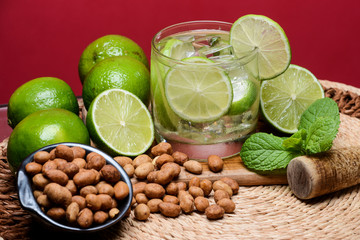 Refreshing cocktail with green lemon and ice.