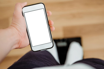 Top view on a white phone with a blank display with a view of the scale. The concept of checking...
