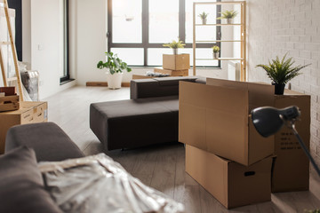 Fototapeta premium Room full of box containers and stuff for cleaning. Move, packing and unpacking.