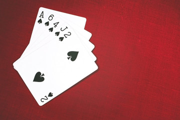 Cards for Poker on a red background, flush.