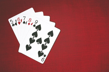 Cards for Poker on a red background, straight.