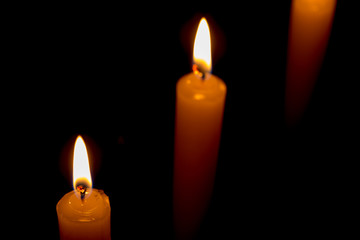 candle lit brightly against a black background