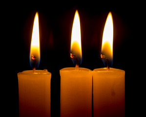 candle lit brightly against a black background