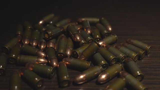 Bullets lie on the table. Illuminated lights 4k