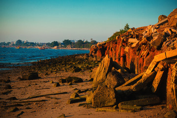 Red sunlight over a rocky seashore. Sunset landscape.Landscape sunset.Sunset orange sunrise on the rocky coast in the evening.