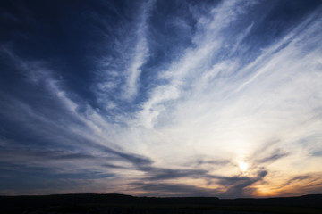 Obraz premium Sunset in cyclone clouds sky. Cloudscape