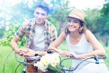 Young beautiful couple riding bikes in summer