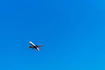 View of the plane against the blue sky, Hawaii, USA. Isolated on blue background. Copy space for text.