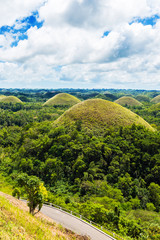 View of the Chocolate hills on sunny day on Bohol island, Philippines. Vertical.