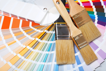 Closeup view of brushes and paint color palette samples