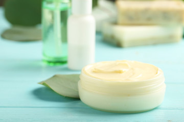 Fototapeta na wymiar Jar with cream on wooden background. Hand care cosmetics