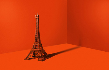 Eiffel tower in an orange room. Minimalistic concept, travel and sightseeing. A metal statue of the...
