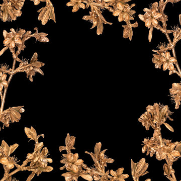 Floral frame made of golden sakura branches on black background. Hand-painted spring flowers