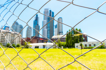 View of the fence on the background of a skyscraper, Buenos Aires, Argentina. With selective focus.