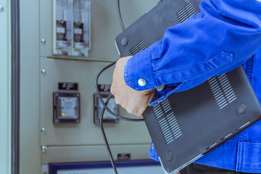 Male engineers are checking the electrical system by program in laptop