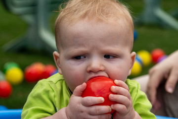 Baby Chewing Red Ball