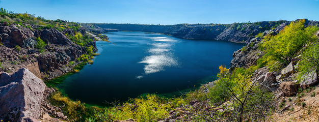 Beautiful view of the lake in a flooded quarry. Village Tokovsky, Apostolovsky district, Ukraine. Panorama.