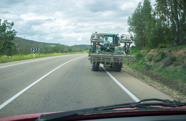 Driving slowly behind a tractor by local rural road