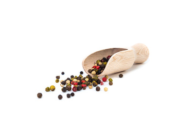 Colorful peppercorns isolated on white background. Colorful pepper on a wooden bucket. The concept...