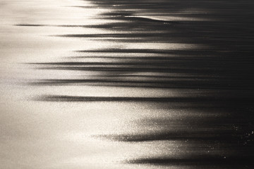 the play of light on wet sand in the evening light
