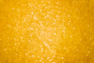 Gold glitter abstract lights background. Christmas yellow blurred bokehю Grain effect added.
