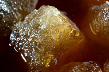 cola with ice cubes close up