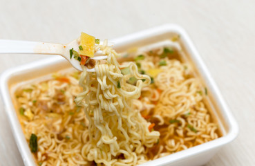 Raw food noodles quickly with a fork on the table