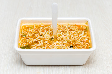 Raw food noodles quickly with a fork on the table