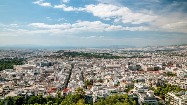 Panoramic view of Athens, Greece. City skyline. White clouds move across the blue sky. Time lapse video.