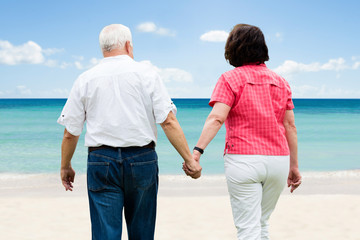 Senior Couple Walking At Beach