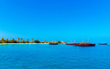 Dhoni boats off the coast of the island, Maldives. Copy space for text.