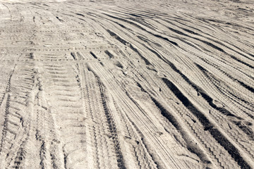 Traces of trucks on the black ground