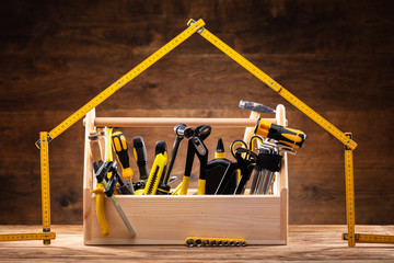 House Made Up Of Measuring Tape Over Toolbox