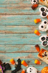 Assorted Halloween candy decorations on rustic blue background