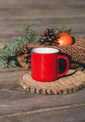 Red cup with a christmas decoration.
