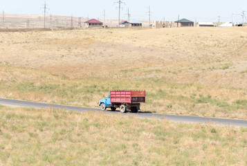 Truck passing by on a green agricultural field